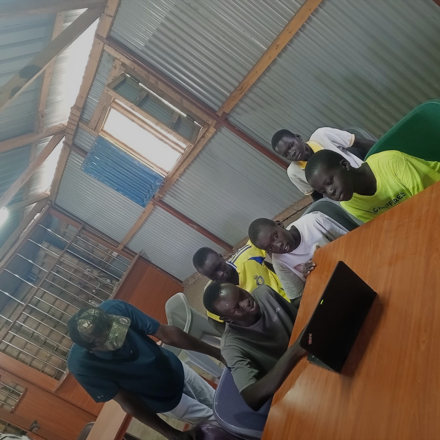 Students gathered around a laptop